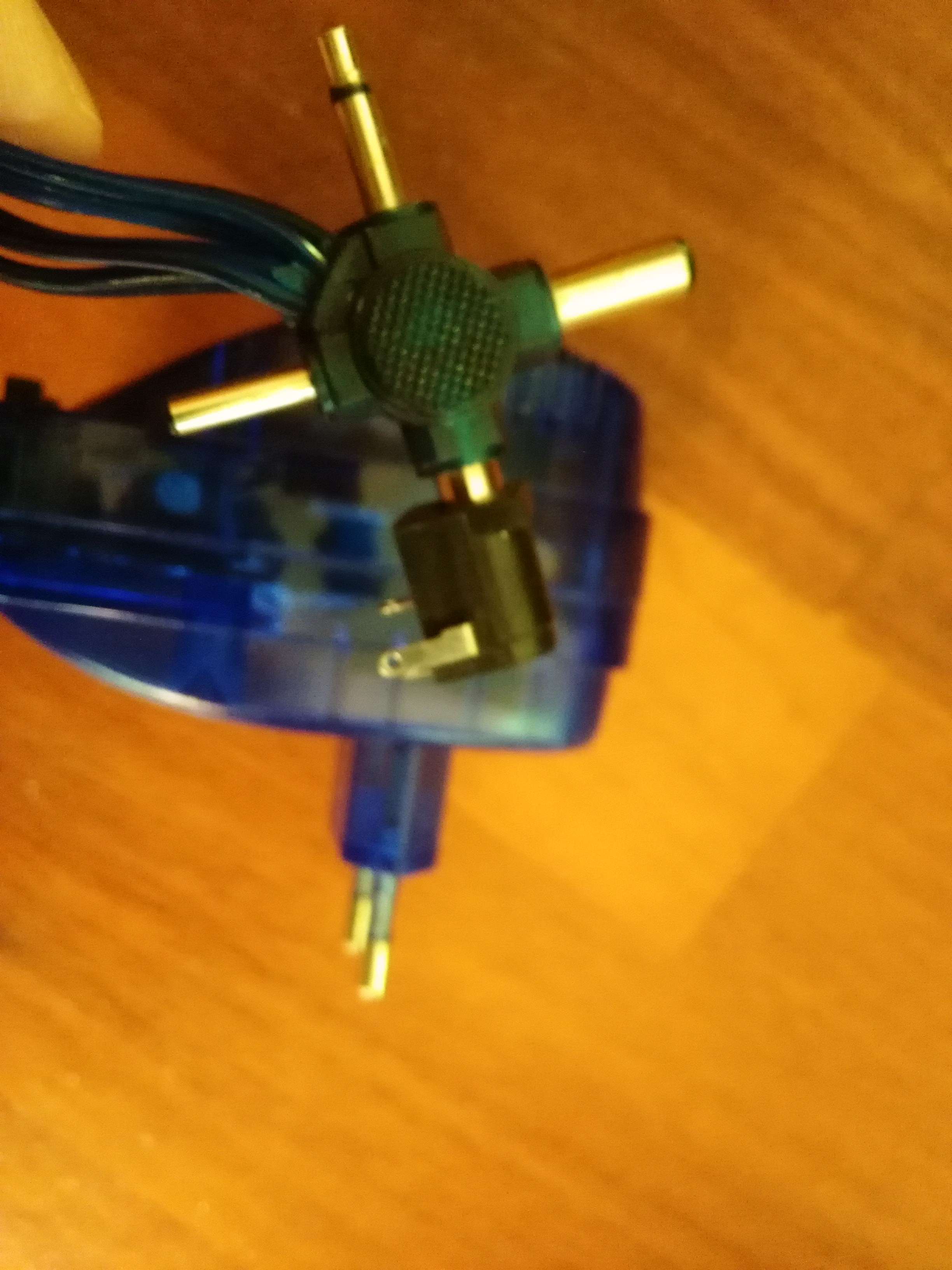 AC/DC adapter connected to a female barrel connector.